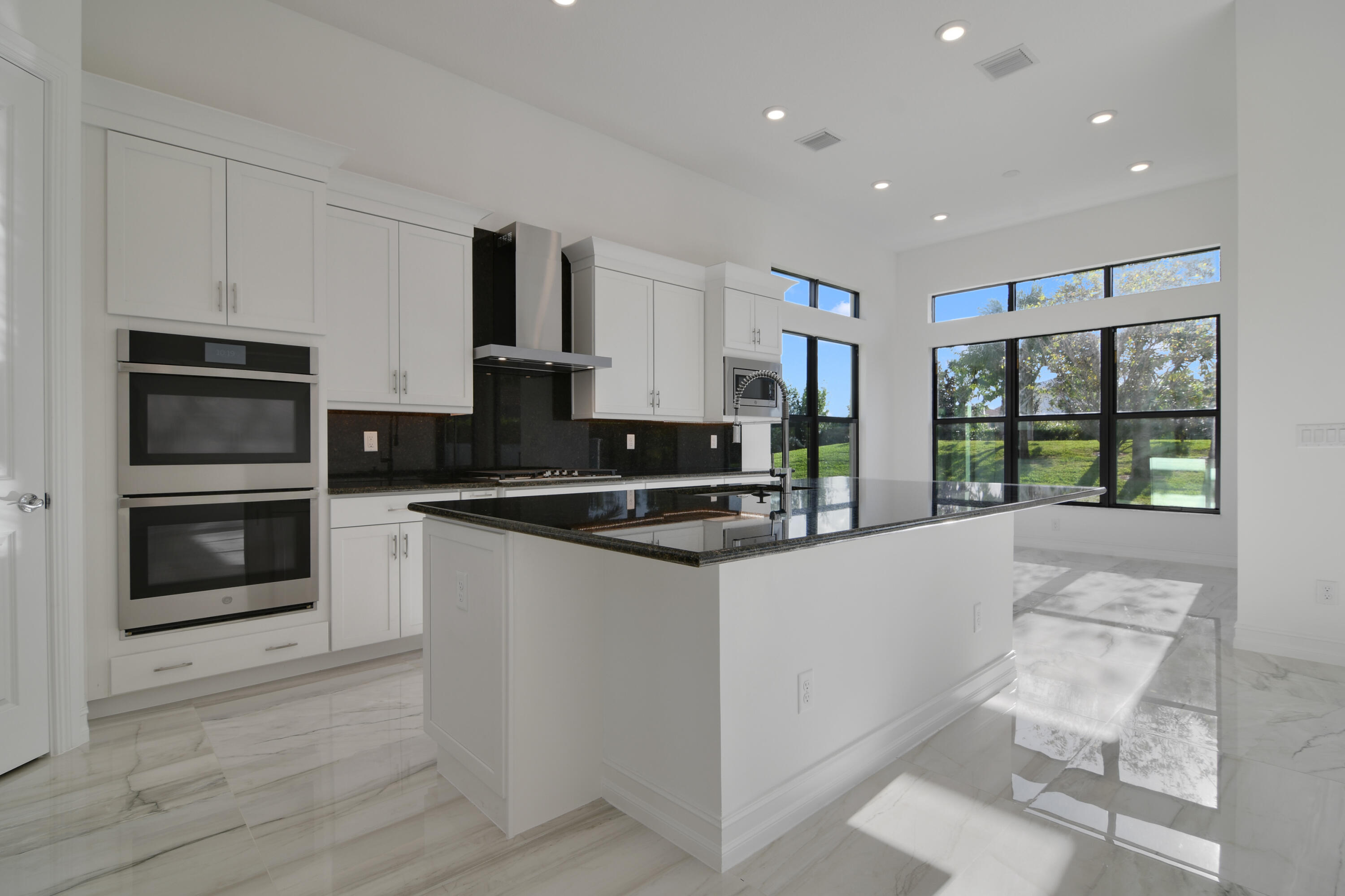 8827 Leon Circle, Unit 286 Parkland, FL 33076 - Photo 10 of 34 a kitchen with stainless steel appliances granite countertop a stove and a refrigerator