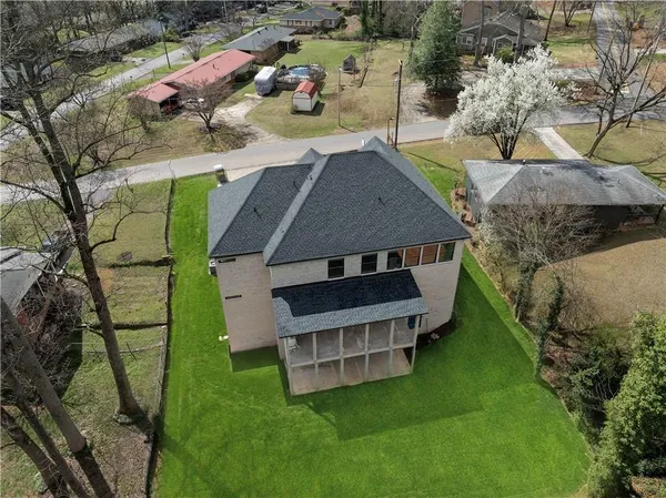 an aerial view of a house with a yard