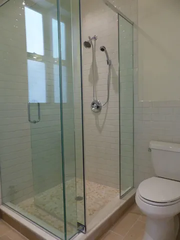 a bathroom with a shower and toilet