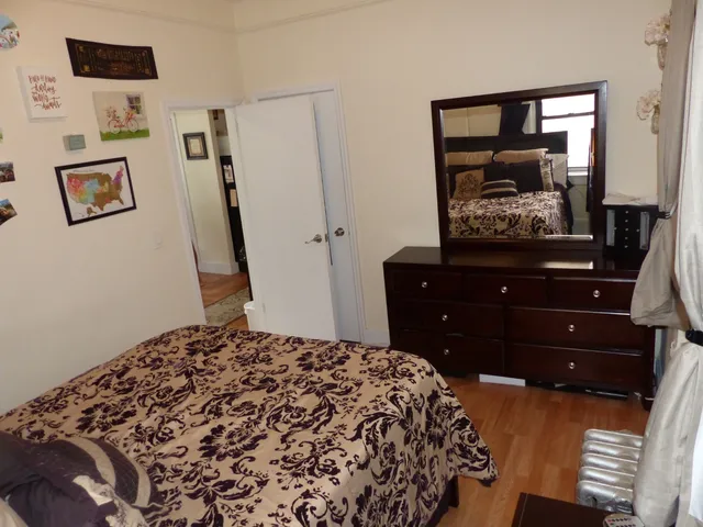 a bedroom with a bed and cabinets