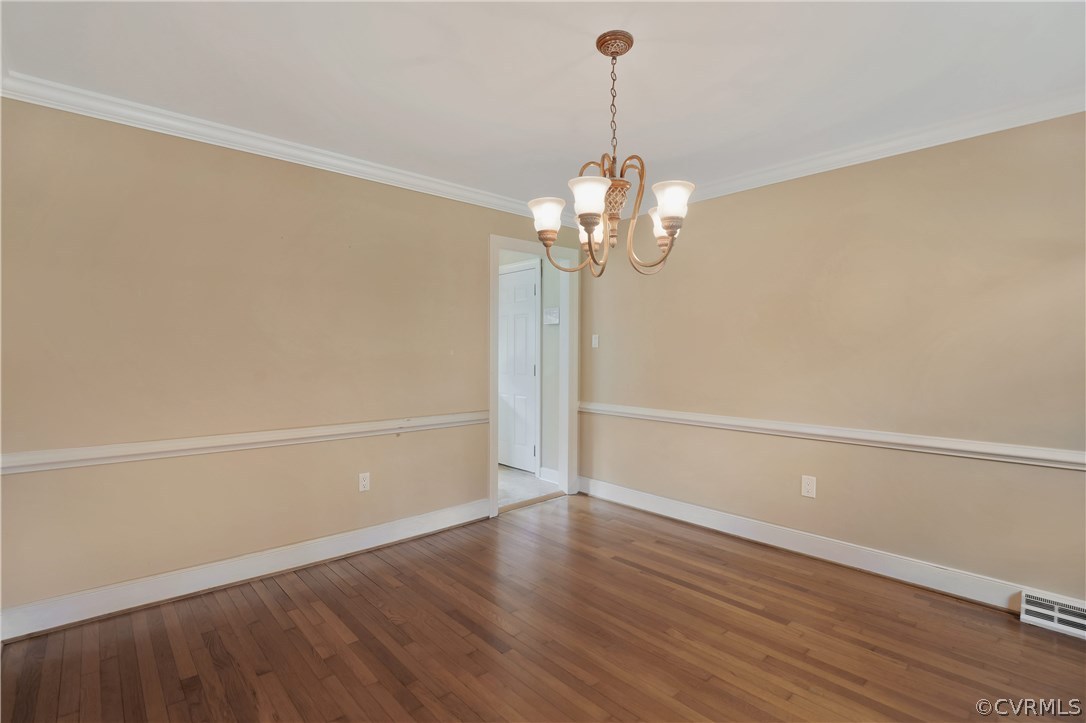 2620 Radstock Road Midlothian, VA 23113 - Photo 11 of 25 a view of a room with wooden floor and chandelier