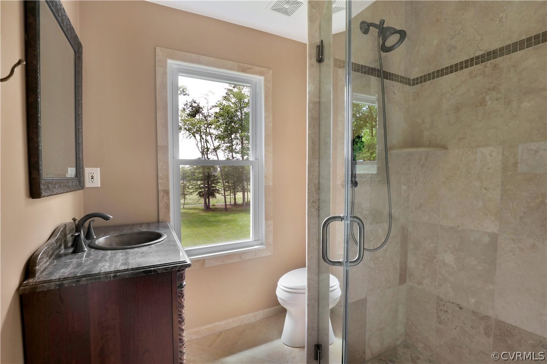 2620 Radstock Road Midlothian, VA 23113 - Photo 21 of 25 a bathroom with a sink a toilet and shower