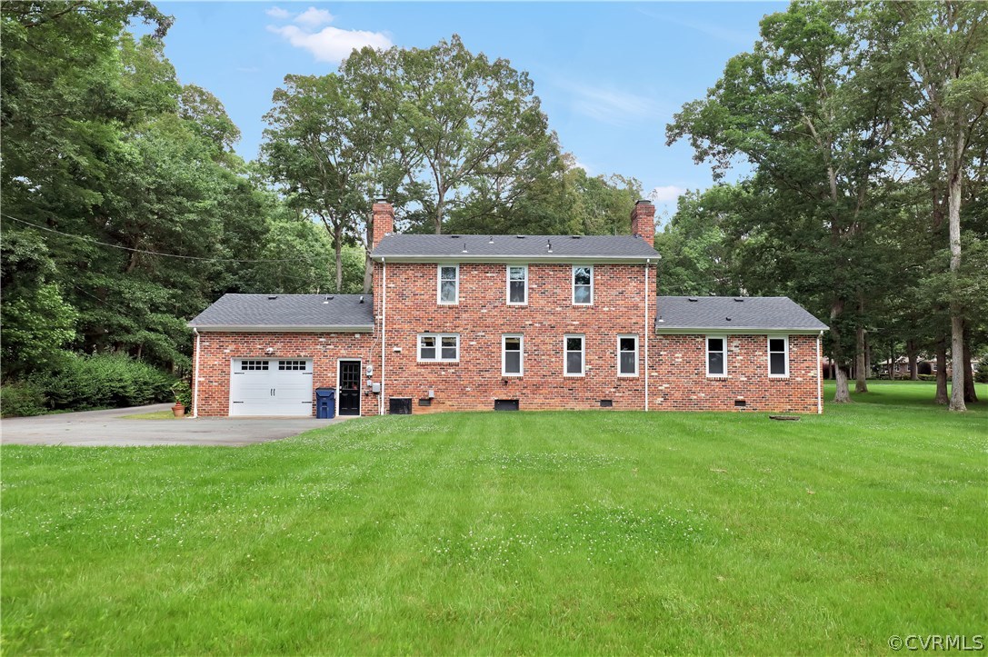 2620 Radstock Road Midlothian, VA 23113 - Photo 23 of 25 a house that is sitting in the grass with large trees and plants
