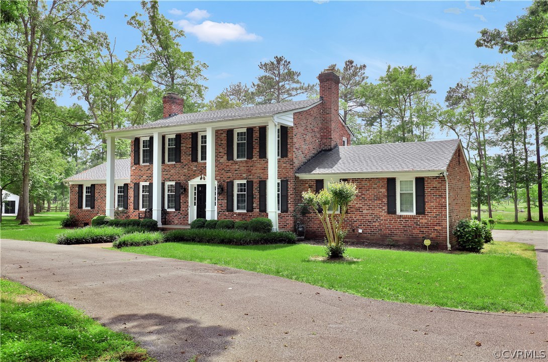 2620 Radstock Road Midlothian, VA 23113 - Photo 3 of 25 a front view of a house with a garden and trees