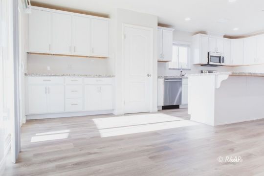 1340 Porter Street Ridgecrest, CA 93555 - Photo 6 of 20 a view of a kitchen with refrigerator and white cabinets