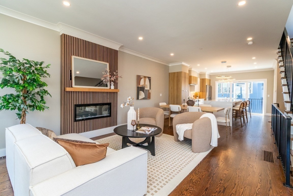 15 Tanglewood Road, Unit D Boston, MA 02126 - Photo 1 of 28 a living room with furniture and a fireplace