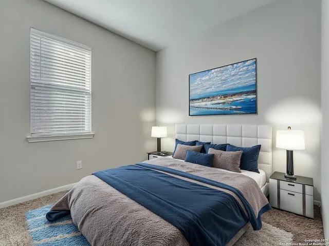 a bedroom with bed and window