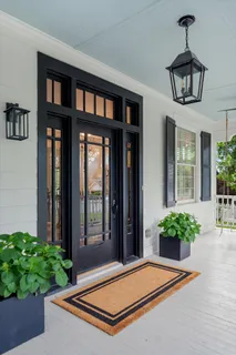 a kitchen with granite countertop white cabinets and sink