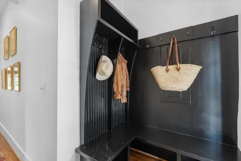 a kitchen with stainless steel appliances granite countertop white cabinets sink and window