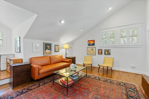 a kitchen with stainless steel appliances granite countertop a stove a sink dishwasher a refrigerator white cabinets and wooden floor