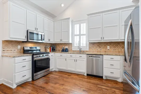a living room filled with furniture and a potted plant