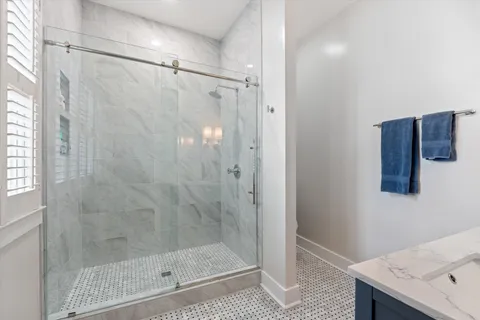 an aerial view of residential house with outdoor space and trees all around