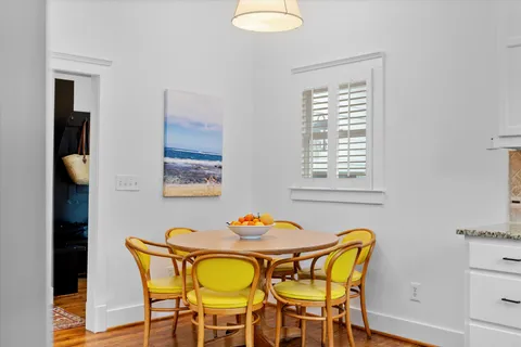 a view of a house with a backyard and a tree