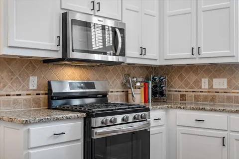 a view of a house with a backyard and a tree