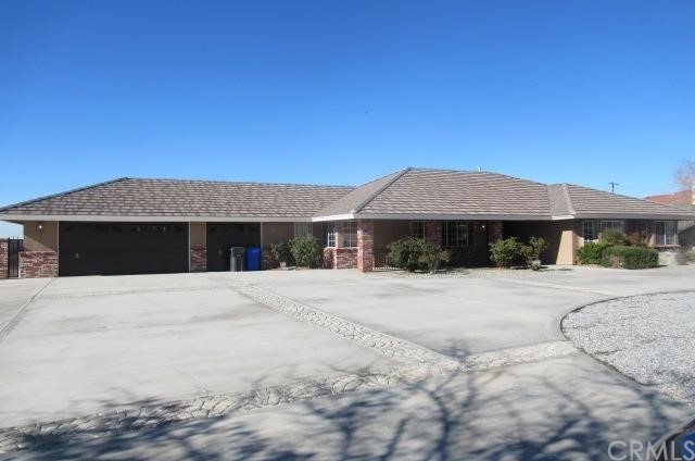 16556 Choco Road Apple Valley, CA 92307 - Photo 1 of 1 a front view of a house with a yard and garage