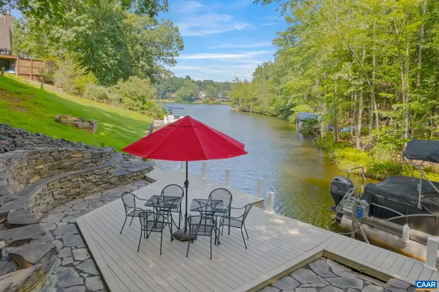 a living room with furniture kitchen view and a wooden floor