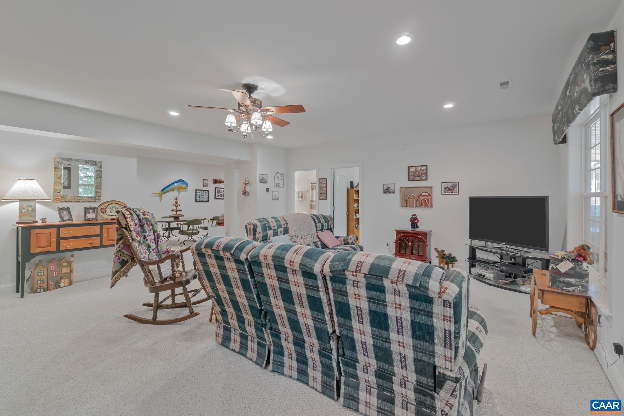 27 Kingswood Road Palmyra, VA 22963 - Photo 25 of 60 a living room with lots of furniture and a flat screen tv