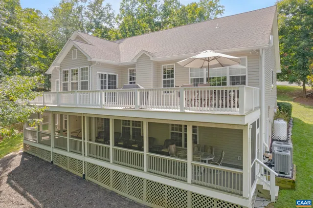 a front view of a house with a garden and plants