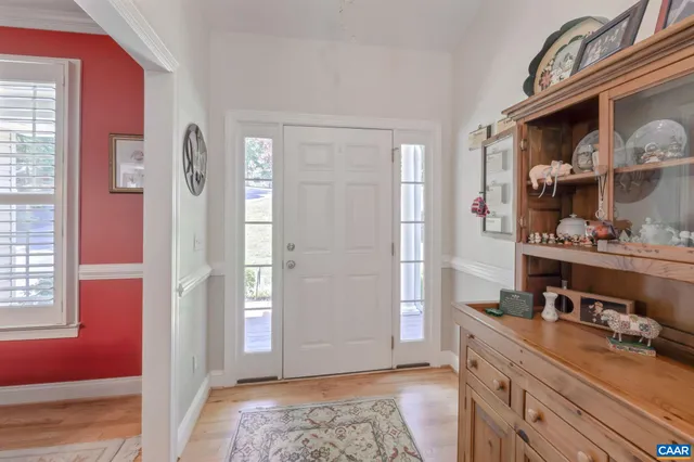 a living room with furniture a fireplace and a chandelier