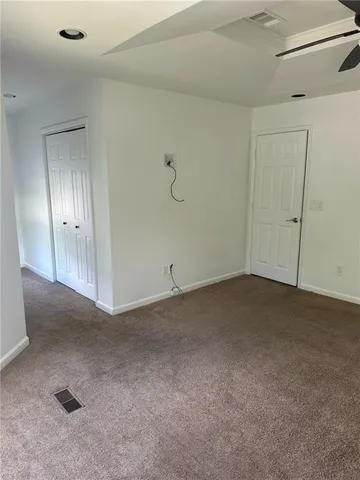 a kitchen with stainless steel appliances granite countertop a refrigerator sink and white cabinets