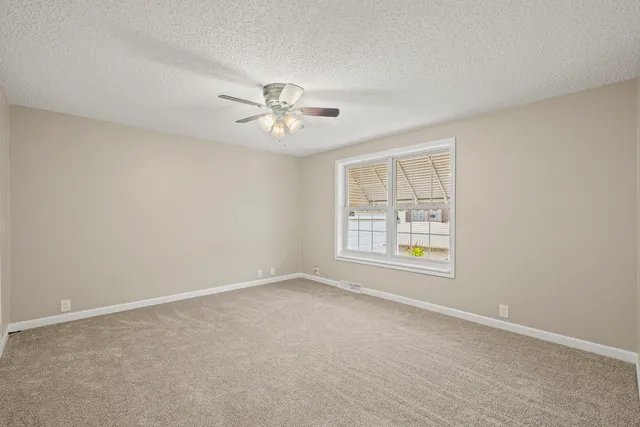 an empty room with a empty space and a window