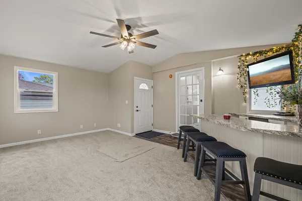 a view of a workspace with furniture and a window
