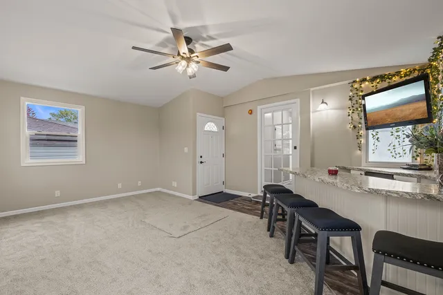 a view of a workspace with furniture and a window