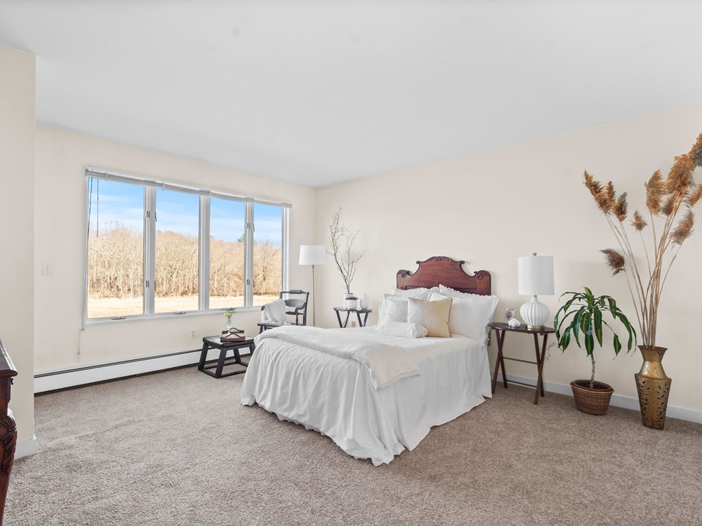15 Upland Road Ipswich, MA 01938 - Photo 8 of 42 a spacious bedroom with a bed and a large window
