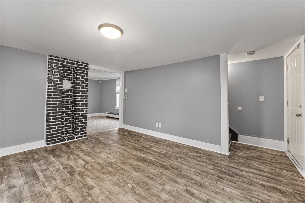 25 Durham Street Lawrence, MA 01843 - Photo 14 of 34 a view of an empty room with wooden floor and a window
