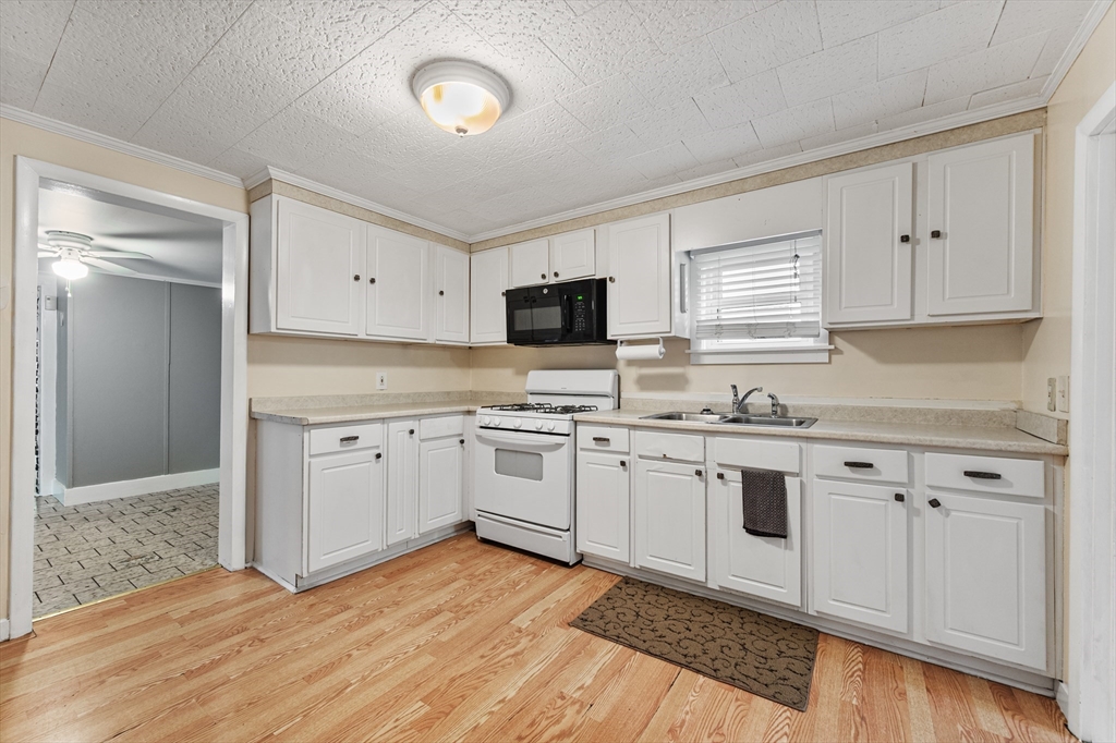 25 Durham Street Lawrence, MA 01843 - Photo 2 of 34 a kitchen with granite countertop cabinets stainless steel appliances and a counter space
