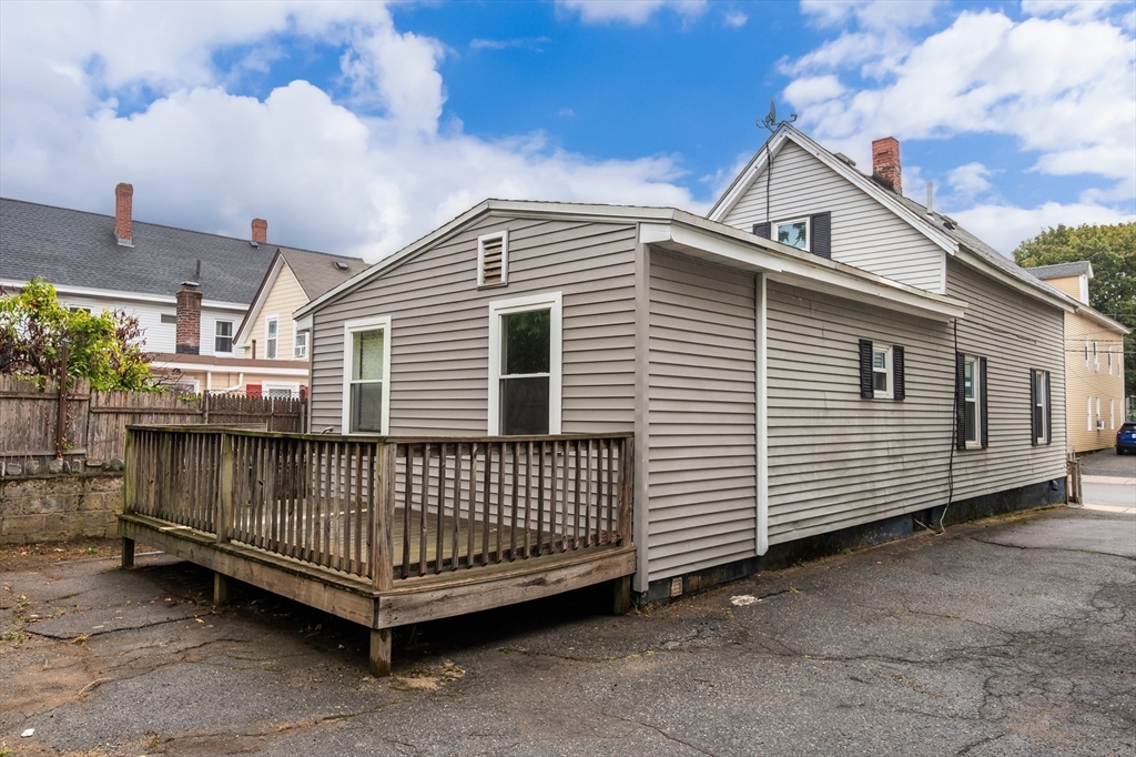 25 Durham Street Lawrence, MA 01843 - Photo 28 of 34 a view of a house with a small yard and wooden fence