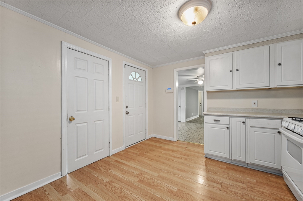 25 Durham Street Lawrence, MA 01843 - Photo 4 of 34 a kitchen with granite countertop white cabinets and white appliances