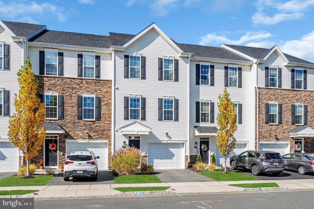a car parked in front of a brick house with a yard