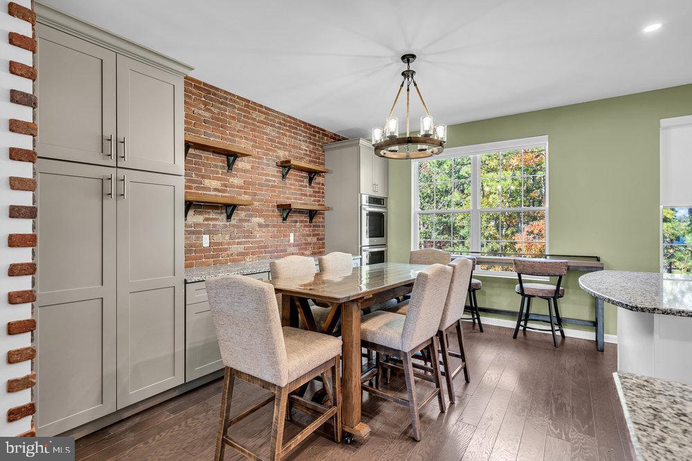 305 Spirit Way Brick, NJ 08723 - Photo 13 of 29 a dining room with furniture a chandelier and wooden floor