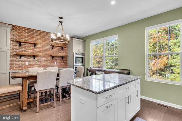 a kitchen with sink cabinets and dining table