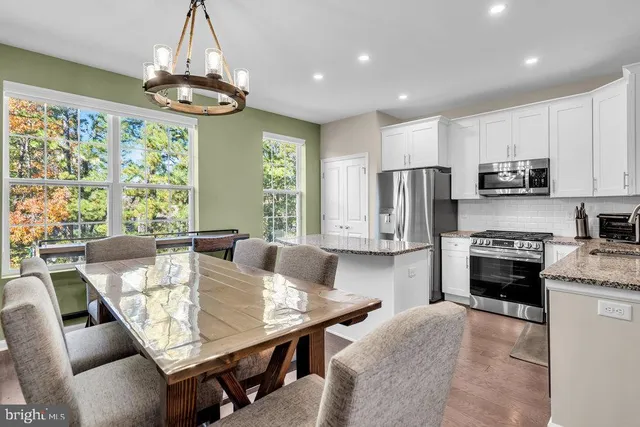 a view of kitchen with sink dining table and chairs