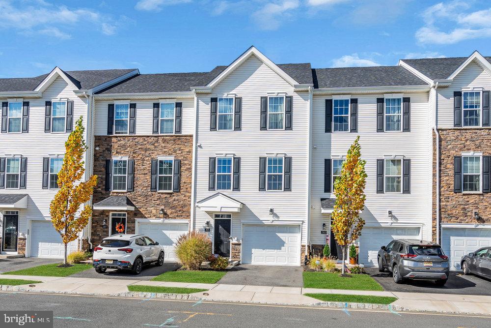 305 Spirit Way Brick, NJ 08723 - Photo 2 of 29 a front view of a residential apartment building with a yard