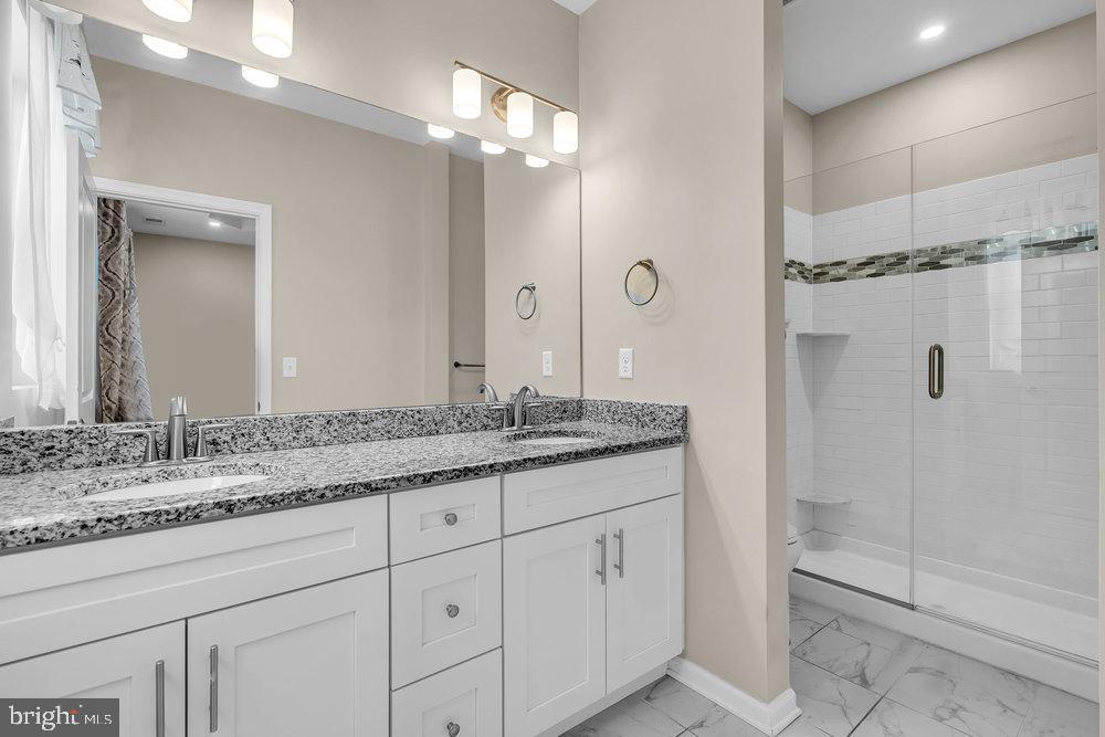 305 Spirit Way Brick, NJ 08723 - Photo 21 of 29 a bathroom with a granite countertop sink a mirror and a shower