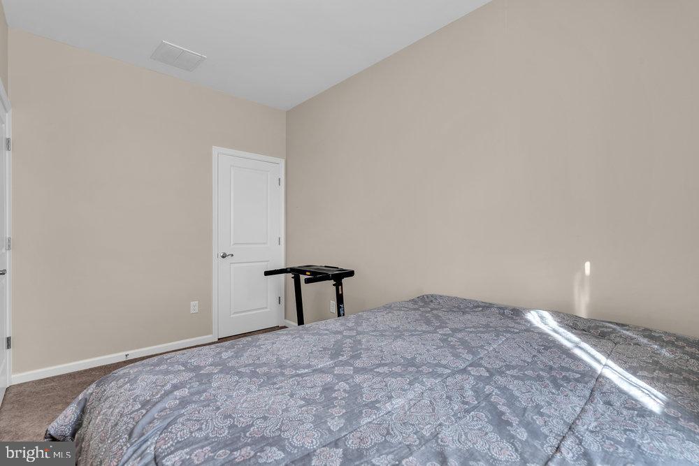 305 Spirit Way Brick, NJ 08723 - Photo 23 of 29 a bedroom with a bed and a table