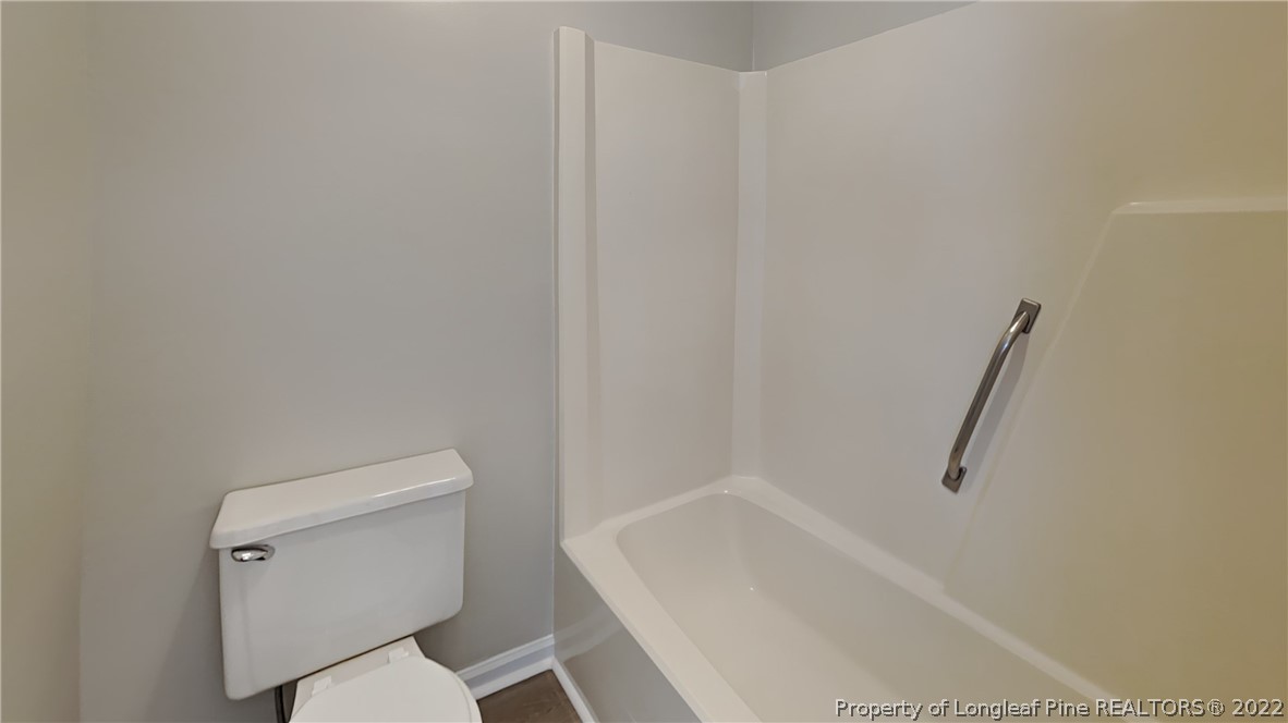 1153 Hoke Loop Road Fayetteville, NC 28314 - Photo 11 of 20 a white bath tub sitting next to a white toilet
