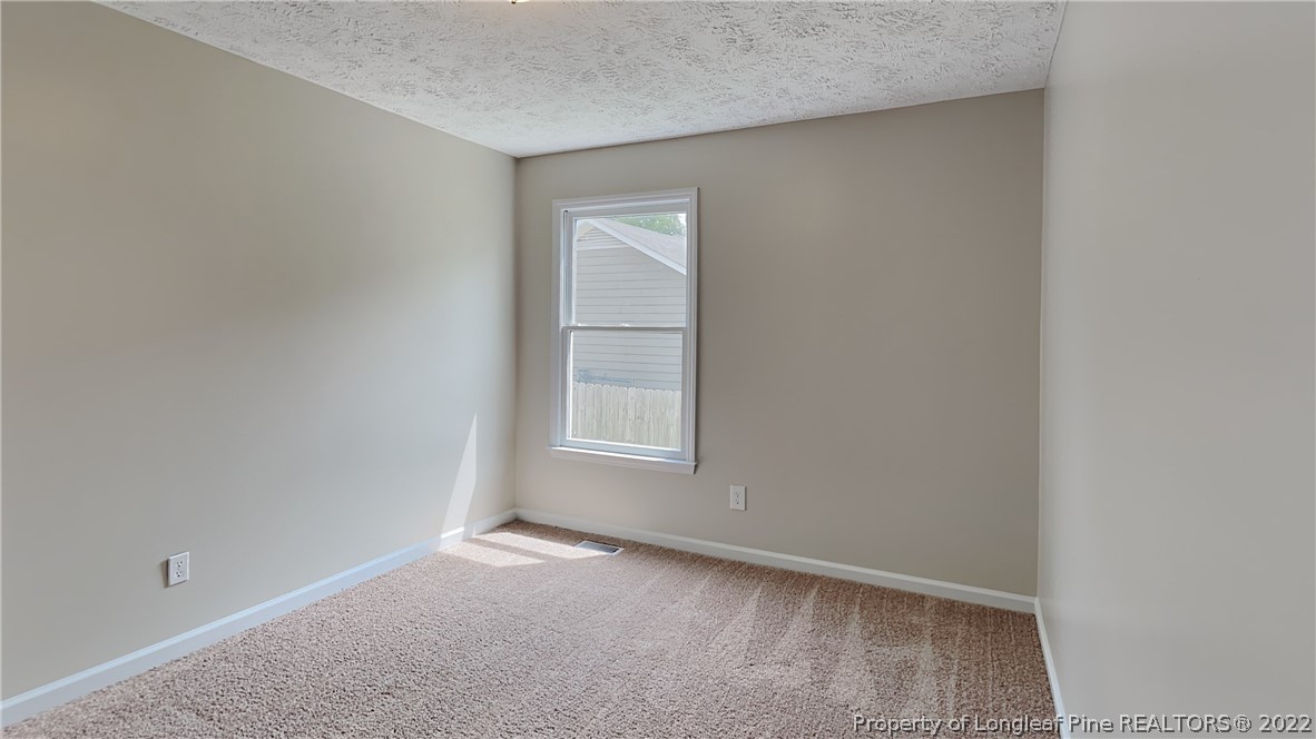 1153 Hoke Loop Road Fayetteville, NC 28314 - Photo 12 of 20 a view of an empty room with a window