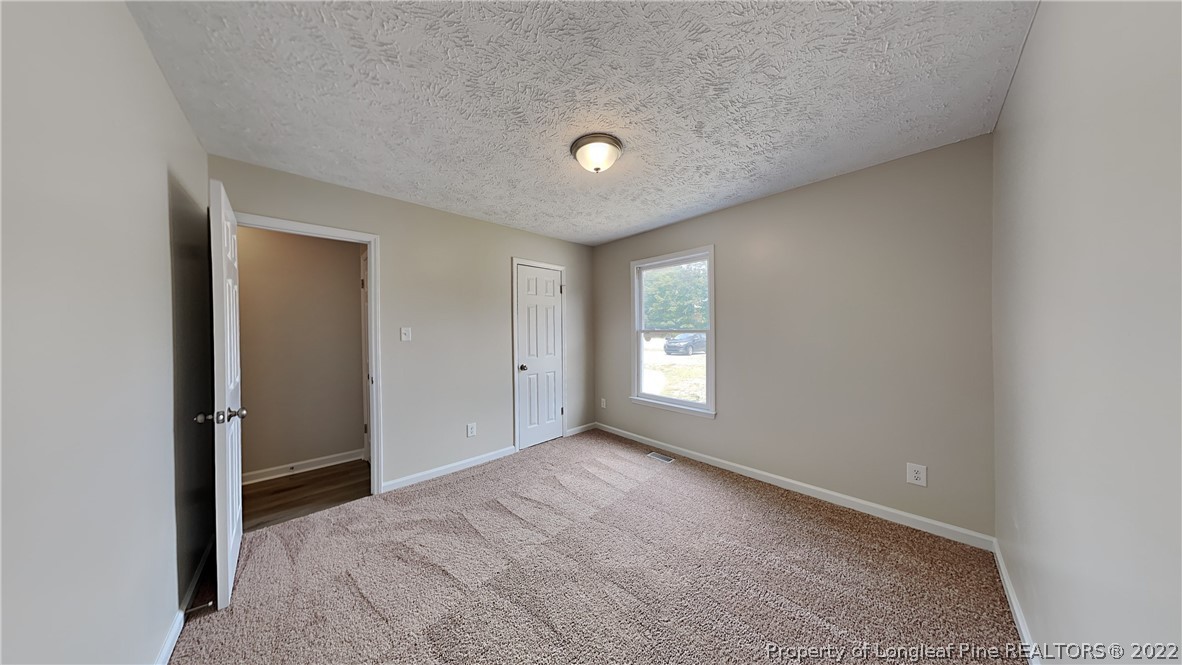 1153 Hoke Loop Road Fayetteville, NC 28314 - Photo 14 of 20 a view of an empty room with a window