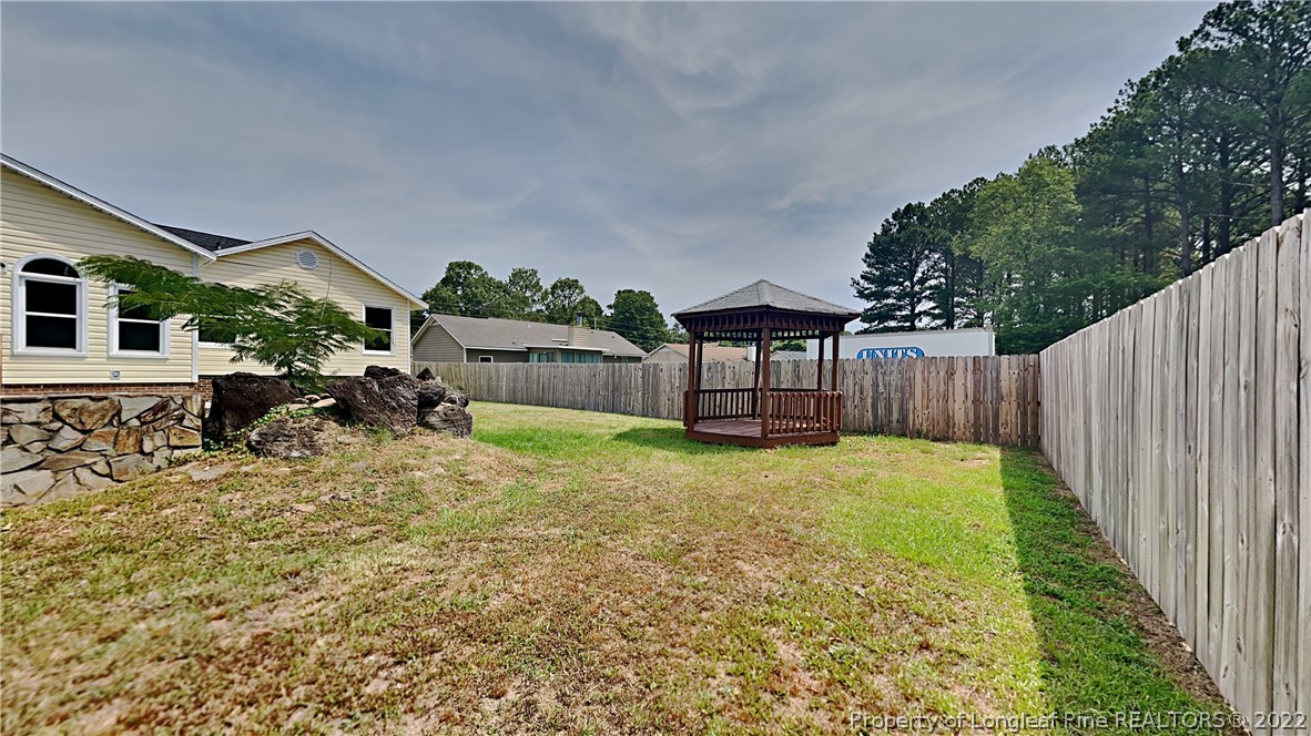 1153 Hoke Loop Road Fayetteville, NC 28314 - Photo 19 of 20 a backyard of a house with table and chairs