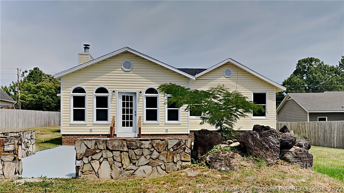 1153 Hoke Loop Road Fayetteville, NC 28314 - Photo 20 of 20 front view of a house with a patio