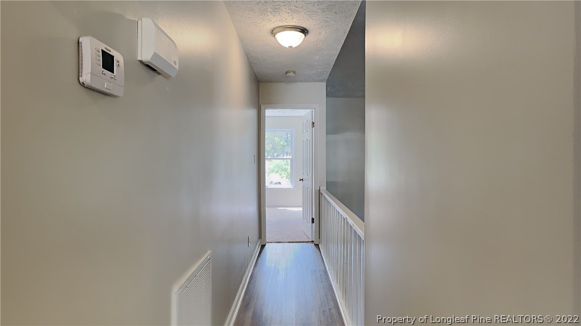 1153 Hoke Loop Road Fayetteville, NC 28314 - Photo 2 of 20 a view of a hallway with wooden floor