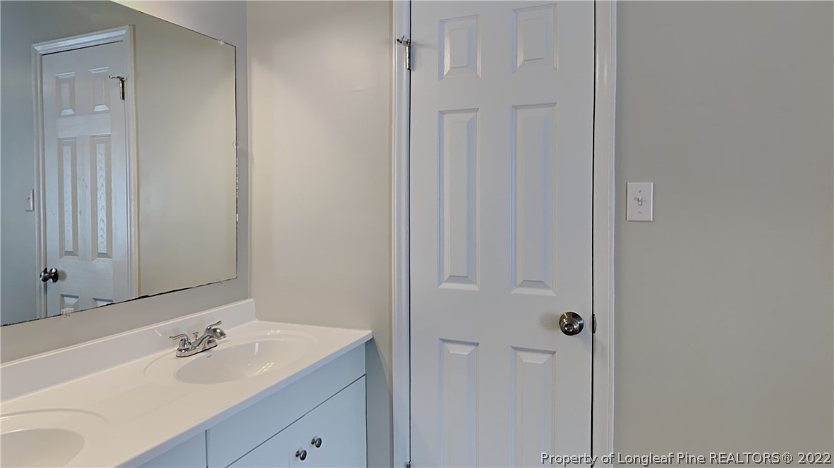 1153 Hoke Loop Road Fayetteville, NC 28314 - Photo 10 of 20 a bathroom with a sink and a mirror