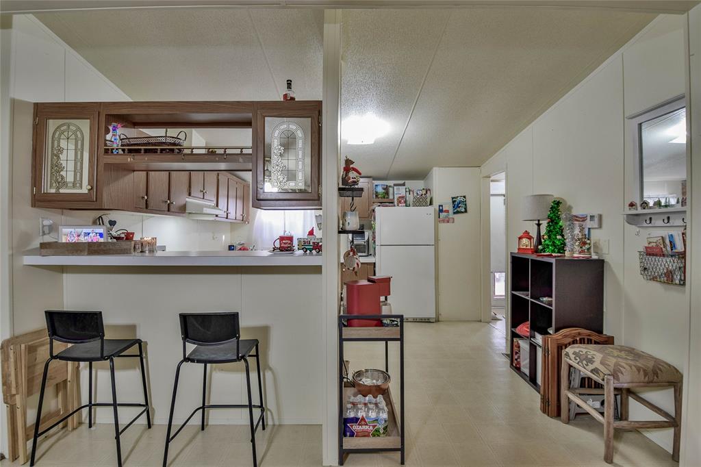 214 Gandy Street Lipan, TX 76462 - Photo 13 of 40 a kitchen with stainless steel appliances granite countertop a refrigerator and a dining table