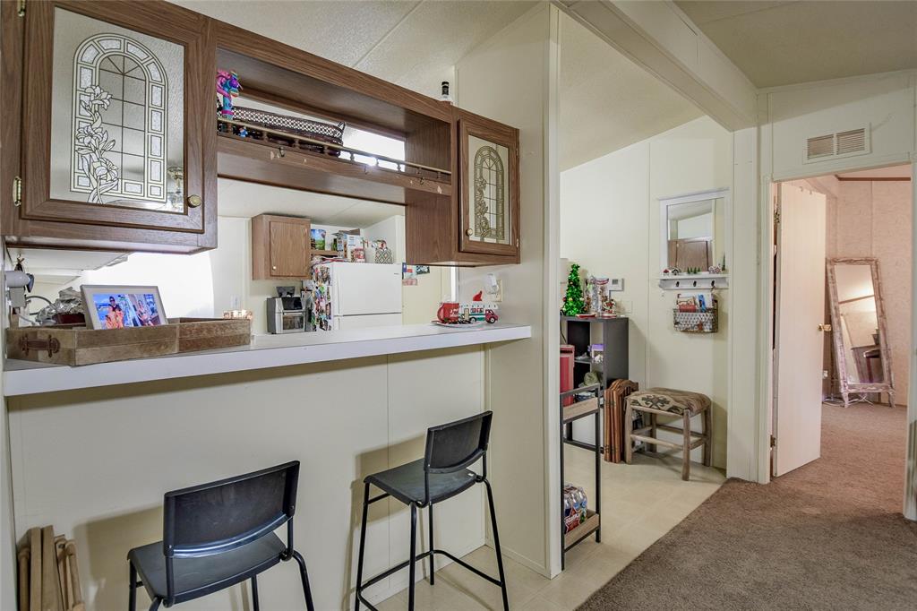 214 Gandy Street Lipan, TX 76462 - Photo 14 of 40 a hallway with a couch and chandelier