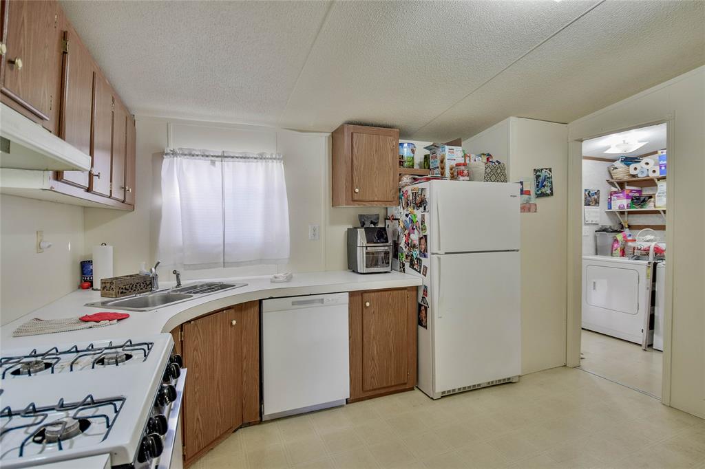 214 Gandy Street Lipan, TX 76462 - Photo 17 of 40 a utility room with cabinets washer and dryer