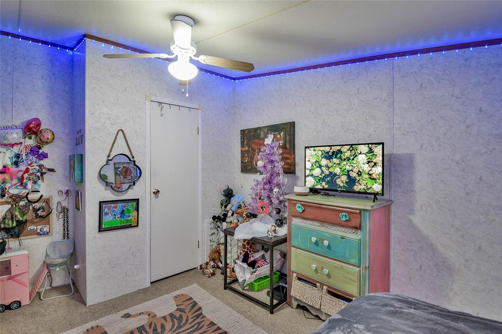 214 Gandy Street Lipan, TX 76462 - Photo 29 of 40 a living room with furniture and a flat screen tv